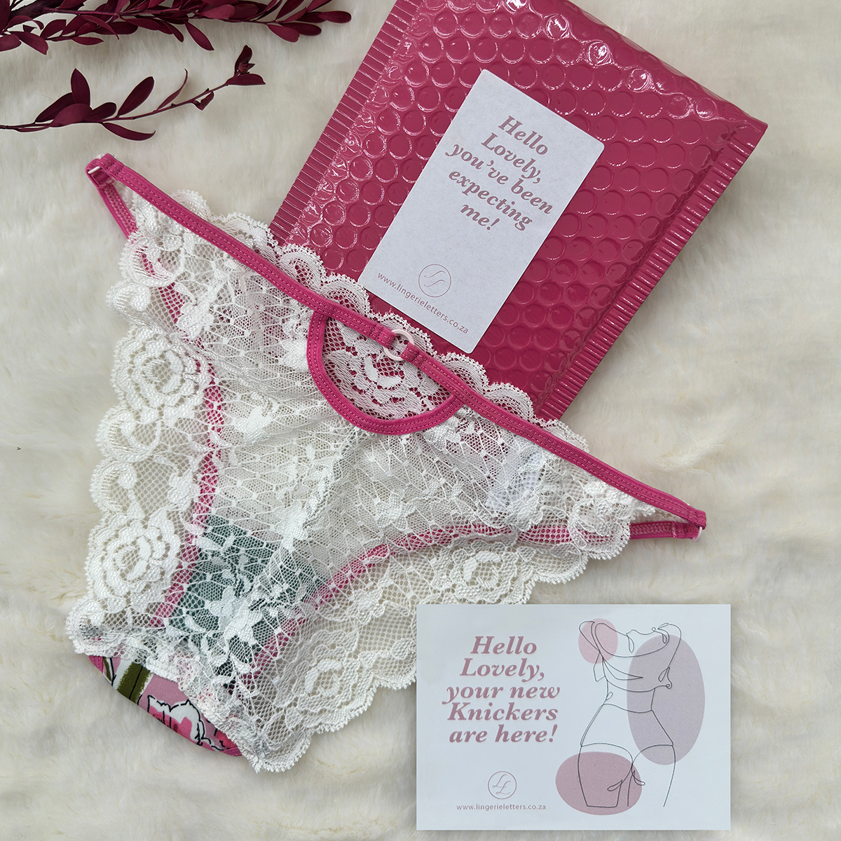 Back view of Lingerie Letters pink floral cheeky brief with white scalloped floral lace and pink elastic.