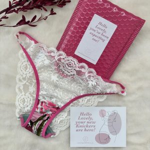 Front view of Lingerie Letters Pink Floral Cheeky Brief with white floral galloon lace, pink printed fabric and pink metal ring detailing.