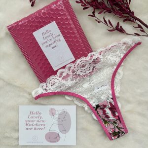 Front view of Lingerie Letters Pink Floral Cheeky Thong with white floral lace and pink Bonbon print.
